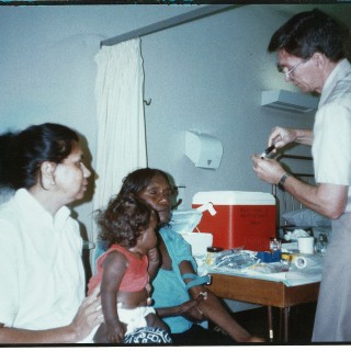 John Mathews and researchers and client in late 1980s doing ear research